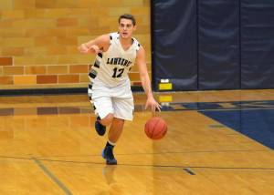 Jeremy Stephani brings the ball up the court earlier this season in Lawrence's win over Carroll.