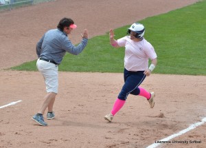 Lawrence's Amanda Jaskolski, right, gets a high-five from head coach Kim Tatro after belting a home run in the Midwest Conference Tournament.