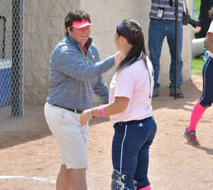 Lawrence head coach Kim Tatro congratulates catcher Sam Belletini during the 2015 Midwest Conference Tournament.