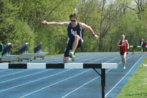 Lawrence's Teddy Kortenhof clears a barrier on his way to winning the 3,000-meter steeplechase at Saturday's Viking Invitational at Whiting Field.