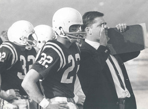 Ron Roberts, right, shouts instructions to the field while being flanked by All-America quarterback Chuck McKee '68.