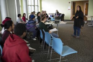 Professor Lori Hilt talks with students at Hiett Hall.