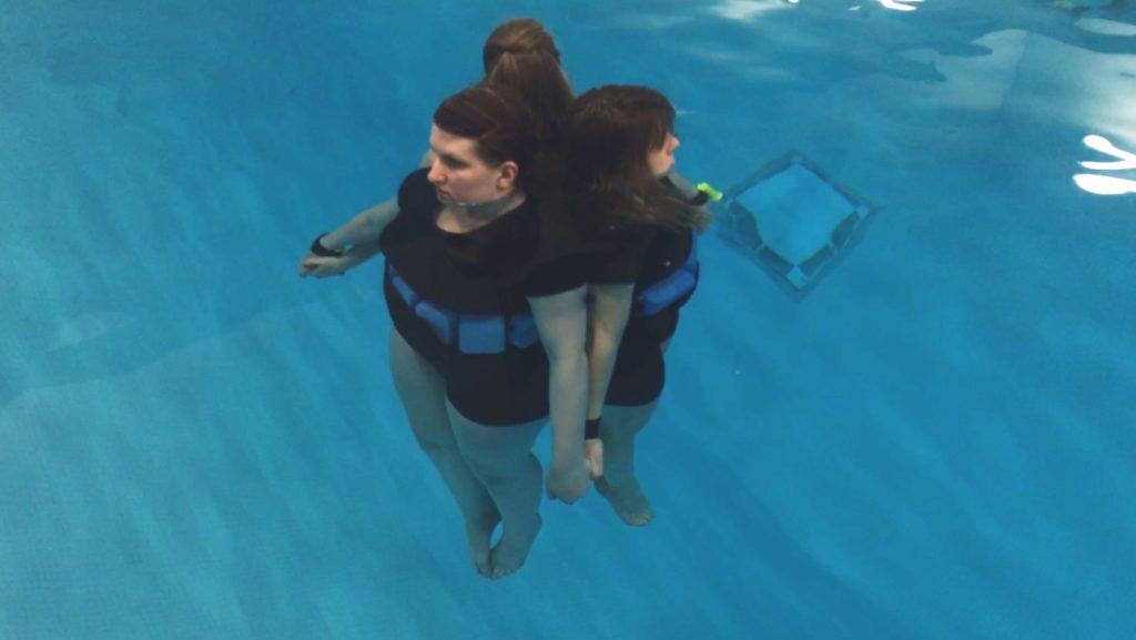 Dancers use float belts as they rehearse for "Breathe" in the Buchanan Kiewit Wellness Center pool.