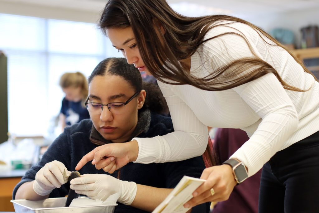 Brianna Wilson '21 (left) looks at a fish while teaching assistant No'eau Simeona '20 stands beside her and collaborates on a lab project for Morphogenesis of the Vertebrates.